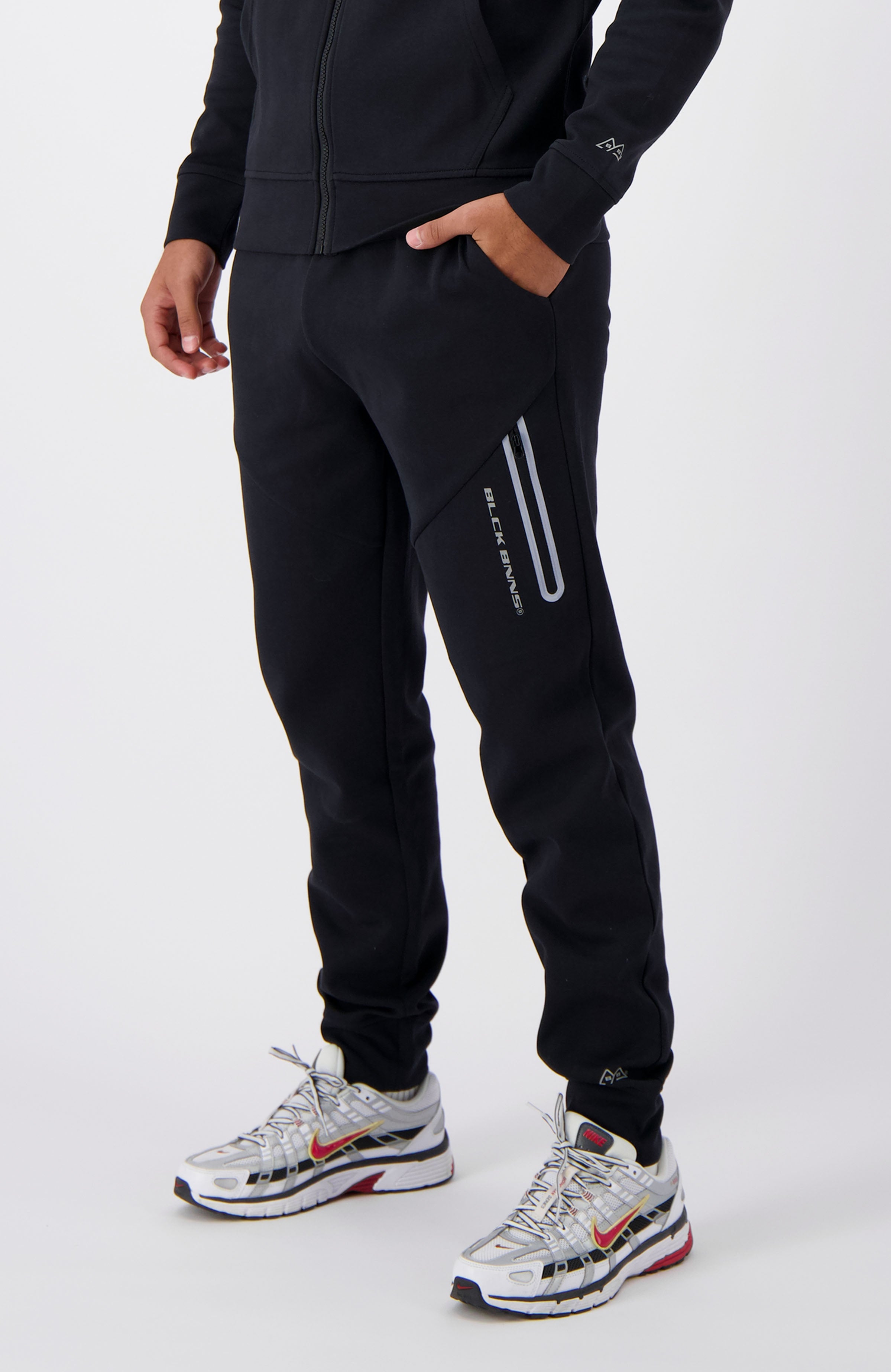 //blackbananas.com/cdn/shop/files/INITIAL_TECH_SWEATPANTS_1.224.2.25-000000-bottom-04_{width}x.jpg?v=1727087262