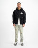 SUDADERA CON CREMALLERA RIPADA | Negra